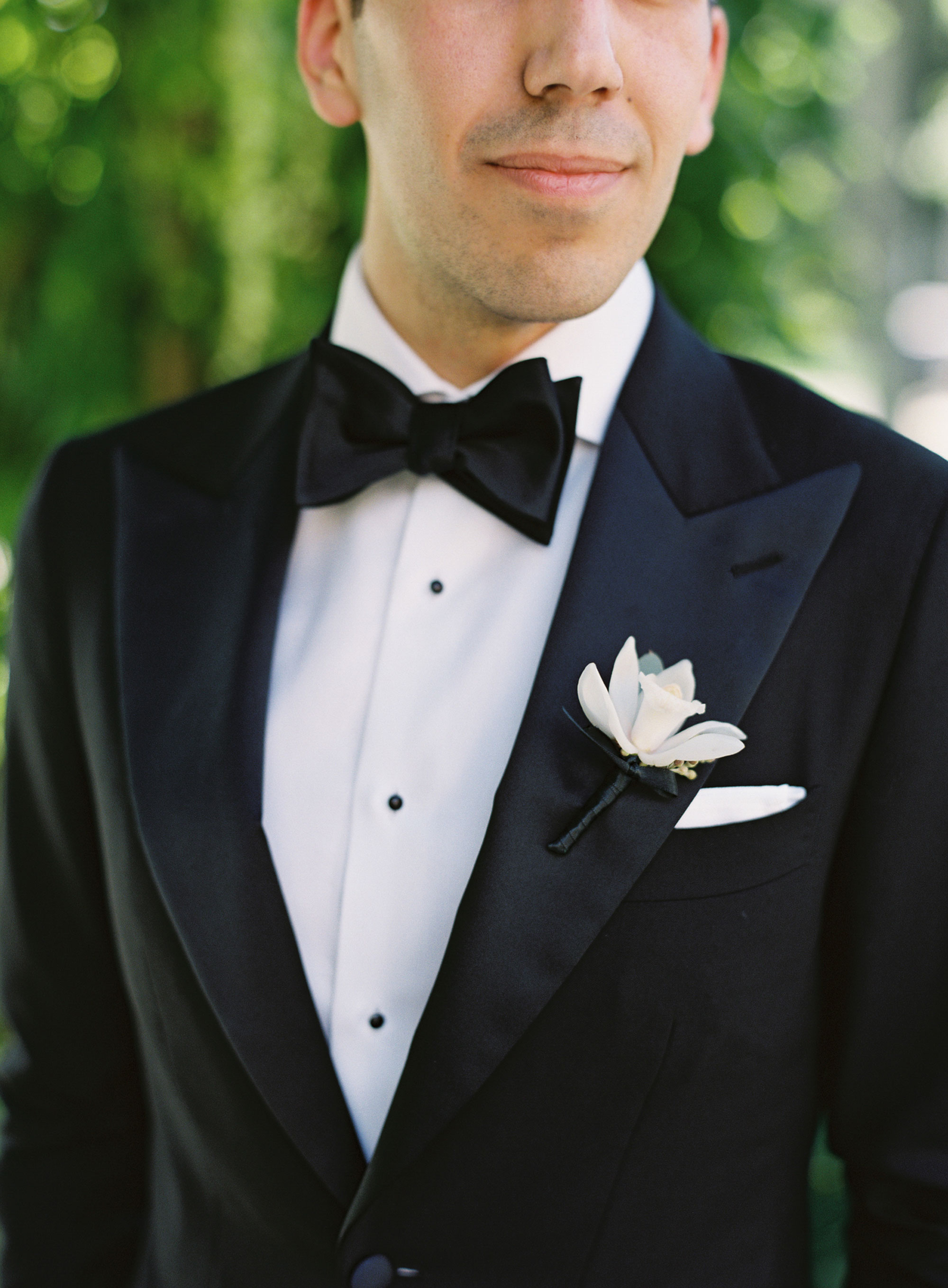 Groom's white orchid boutonniere by David Beam Experiences