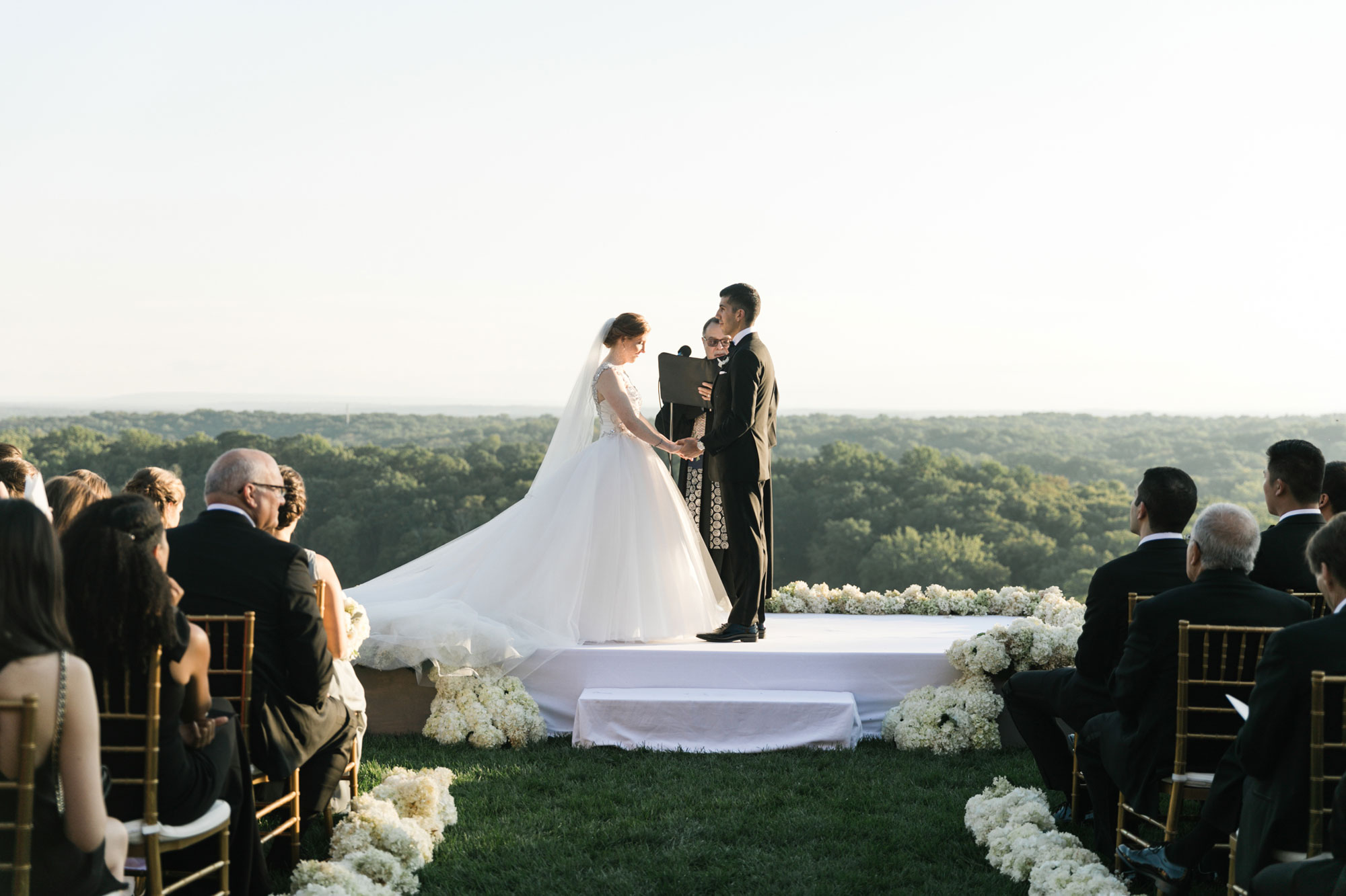 Ceremony at the Mansion at Natirar by NYC wedding planner