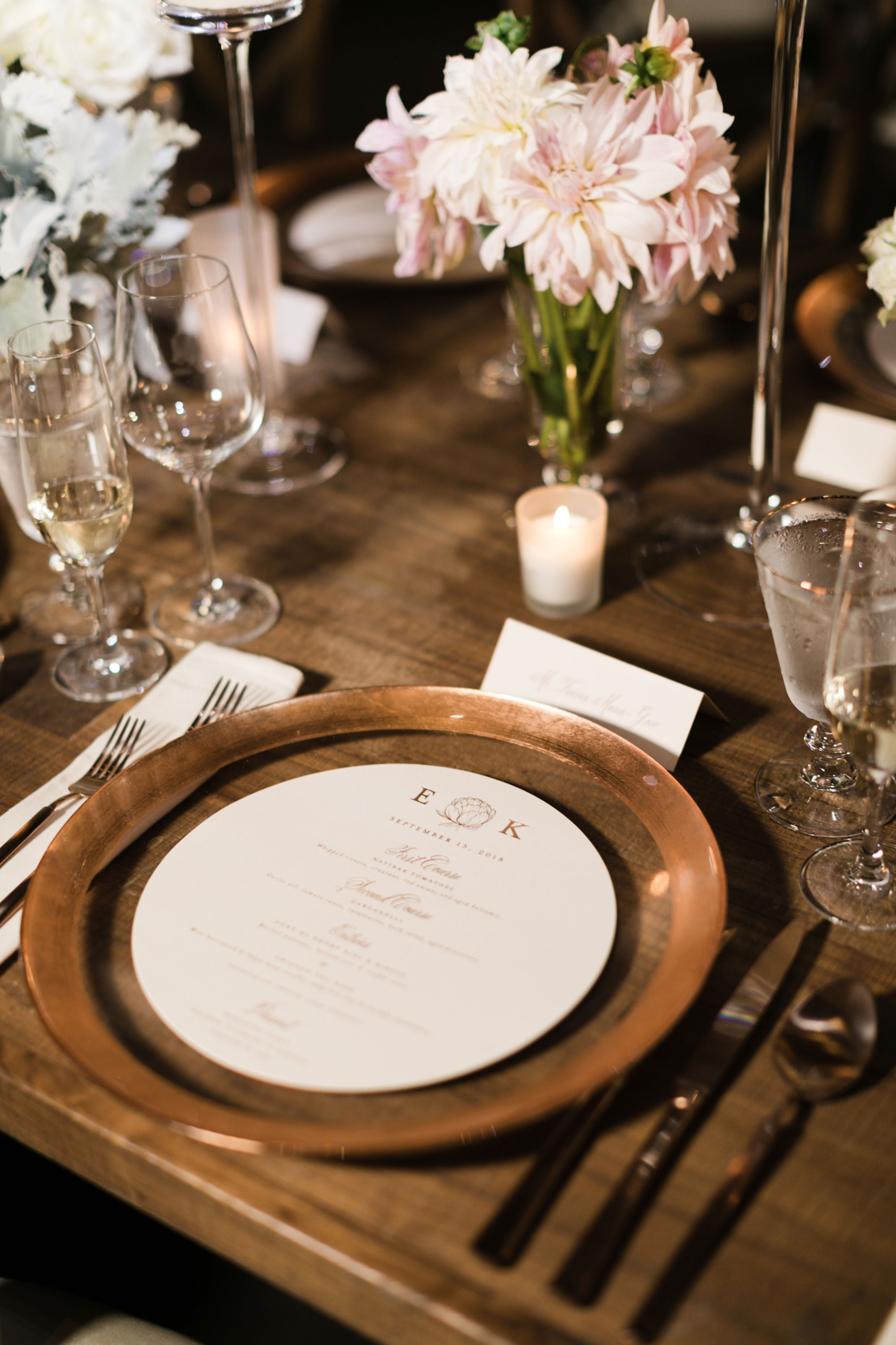 Tablescape and place setting with copper chargers and round menus at the Mansion at Natirar